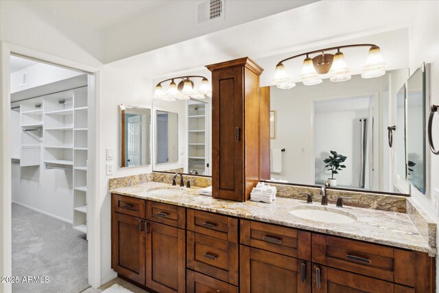 8405 E San Pedro Dr, Scottsdale, AZ 85258 - bathroom featuring double vanity, a walk in closet, and ornate columns