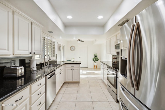 8405 E San Pedro Dr, Scottsdale, AZ 85258 - kitchen featuring stainless steel appliances, a sink, light tile patterned floors, recessed lighting, and white cabinetry