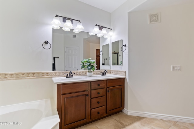 bathroom featuring tile patterned floors, vanity, and a tub to relax in