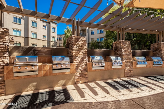 view of patio featuring a pergola, a grill, and exterior kitchen