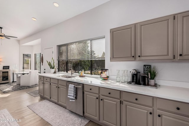 kitchen featuring beverage cooler, gray cabinets, dishwasher, and sink