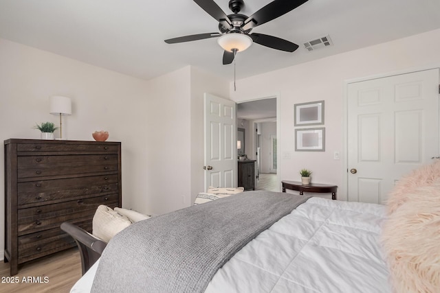 bedroom with ceiling fan and light hardwood / wood-style floors