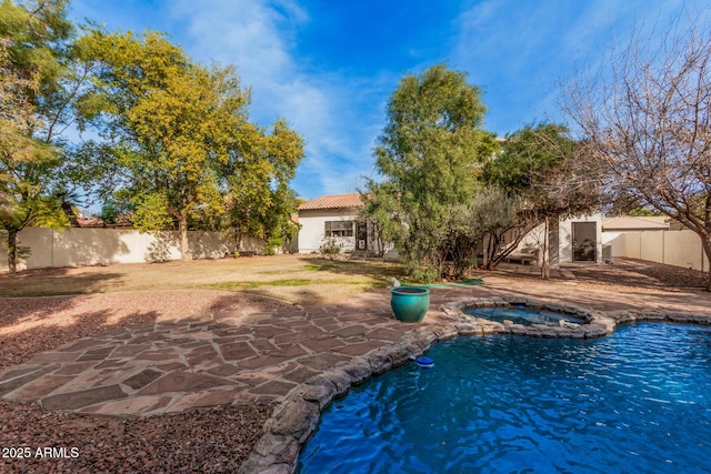 view of swimming pool featuring a patio and an in ground hot tub