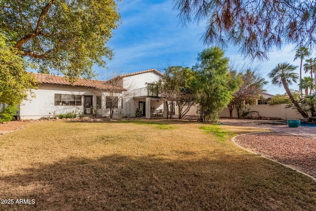 rear view of house with a yard