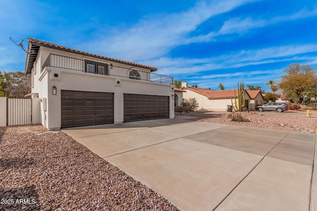 view of front of property featuring a garage and a balcony