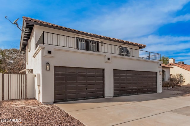 mediterranean / spanish-style house with a balcony and a garage