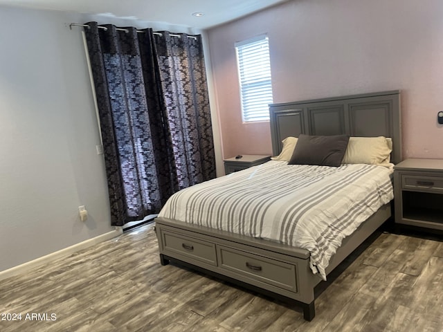 bedroom with hardwood / wood-style floors