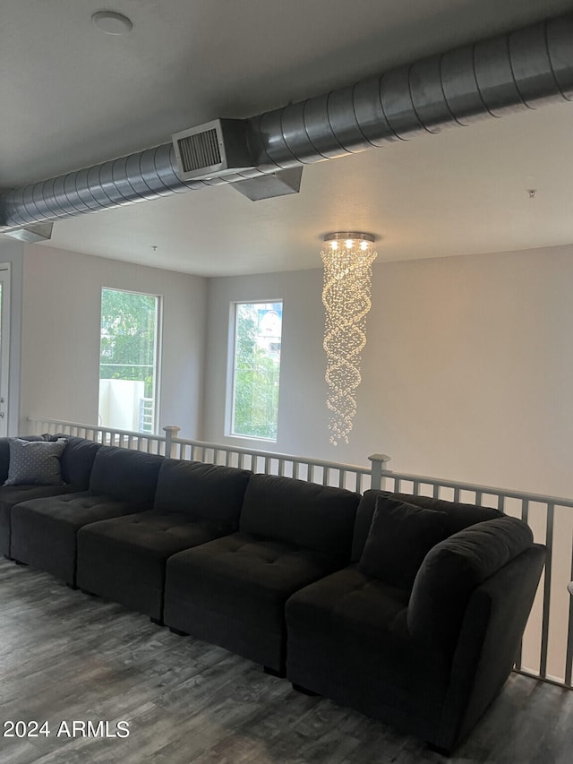 living room with a chandelier and dark hardwood / wood-style flooring