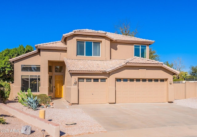 mediterranean / spanish home featuring driveway, a tile roof, a garage, and stucco siding