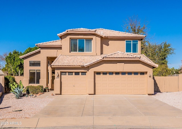 mediterranean / spanish home featuring a tile roof, stucco siding, fence, a garage, and driveway