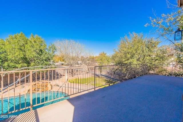 view of patio featuring a fenced in pool and fence