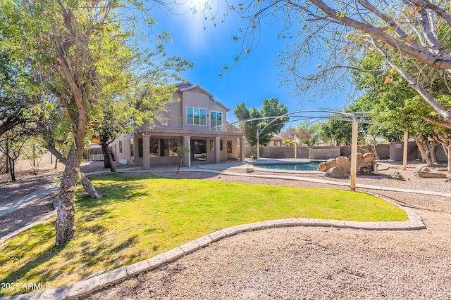 back of house with a fenced in pool, a yard, a patio, and fence