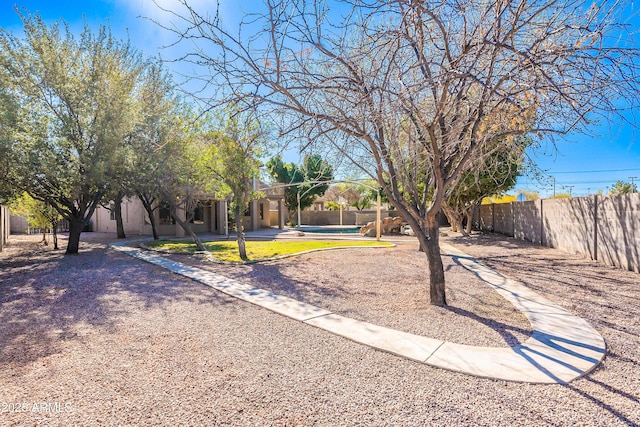 view of yard with a swimming pool and fence