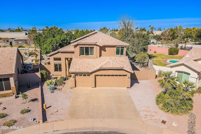 view of front facade featuring a garage, fence, a tiled roof, concrete driveway, and stucco siding