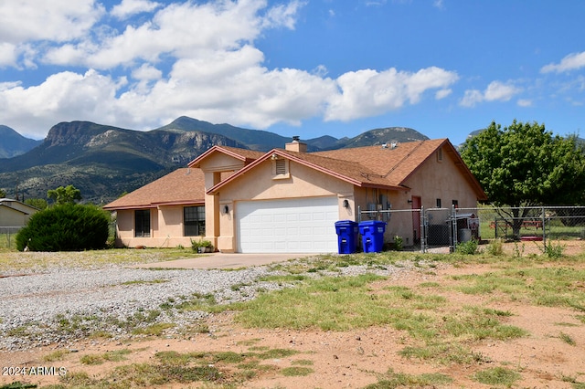 ranch-style house with a mountain view and a garage