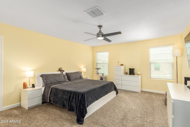 bedroom with ceiling fan and light colored carpet