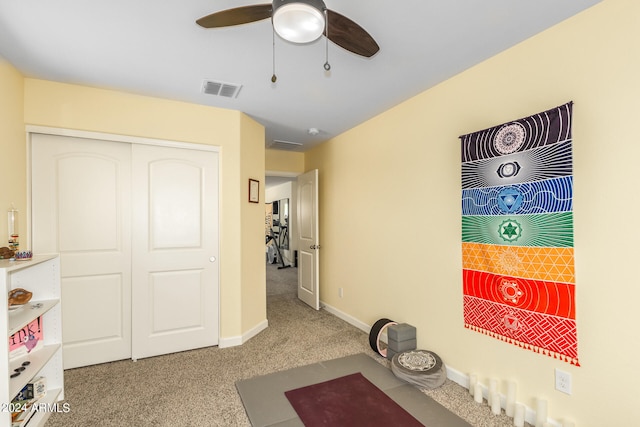 interior space with carpet flooring and ceiling fan