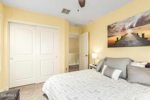 carpeted bedroom with ceiling fan and a closet