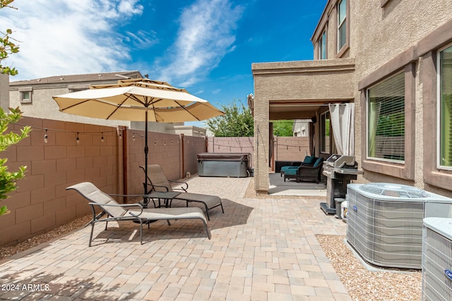 view of patio / terrace with a grill, central AC, and a hot tub