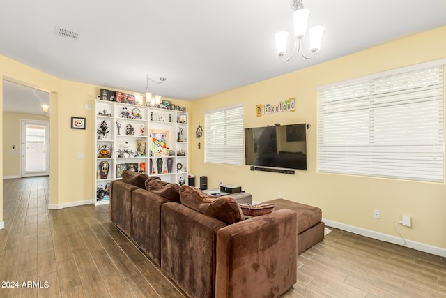 living room featuring hardwood / wood-style floors and a notable chandelier