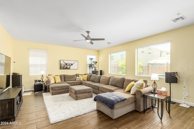 living room with hardwood / wood-style flooring and ceiling fan