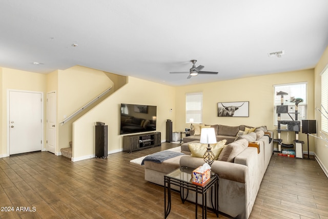 living room featuring dark hardwood / wood-style floors and ceiling fan