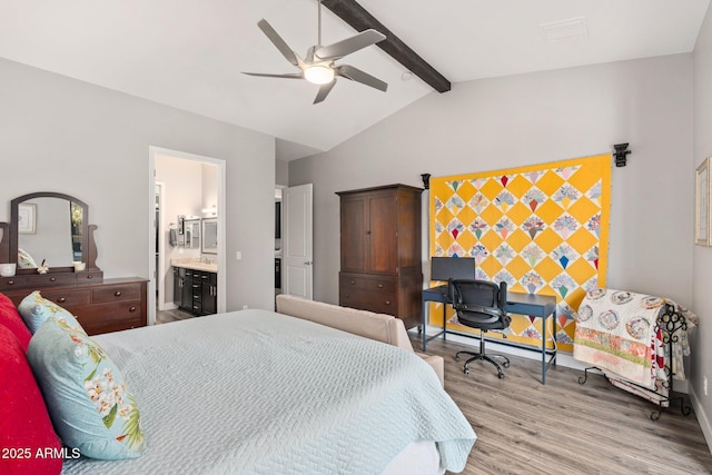 bedroom featuring light wood-style floors, lofted ceiling with beams, a ceiling fan, and ensuite bath