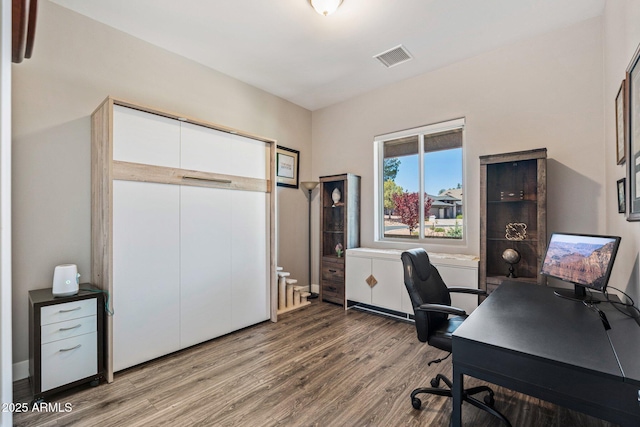 office area featuring wood finished floors and visible vents