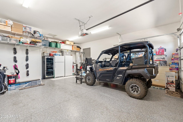 garage featuring a garage door opener and freestanding refrigerator