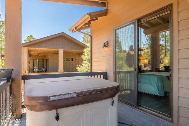 wooden deck featuring a hot tub