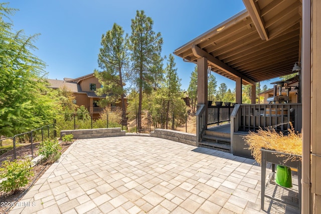 view of patio with fence and a wooden deck