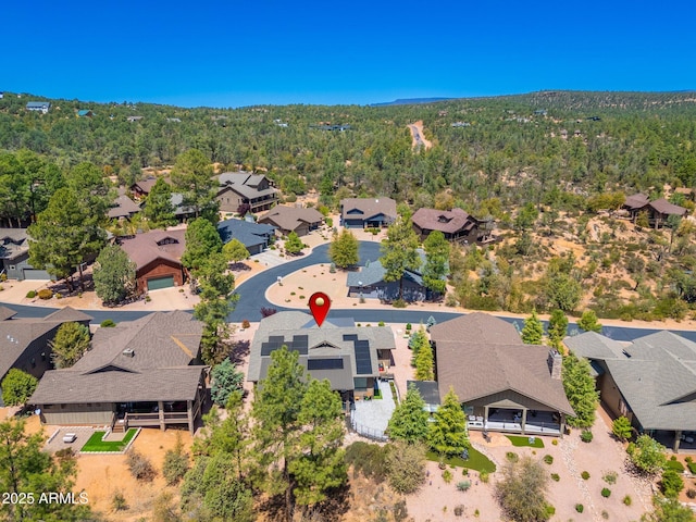 bird's eye view with a wooded view and a residential view