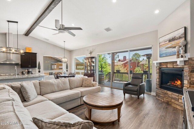 living room featuring recessed lighting, vaulted ceiling with beams, a ceiling fan, visible vents, and wood finished floors