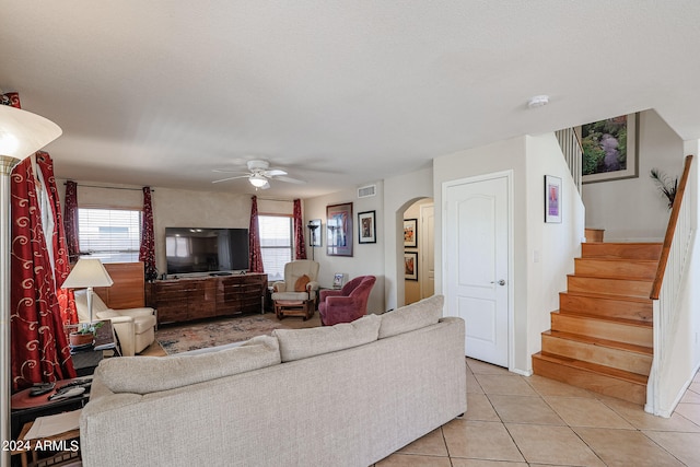 living room featuring ceiling fan and light tile patterned floors