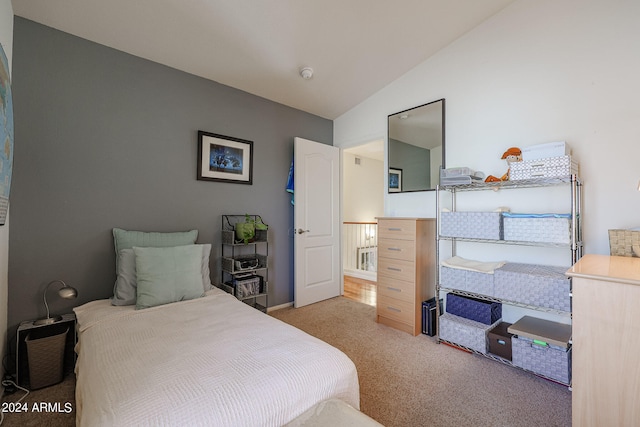 carpeted bedroom featuring lofted ceiling