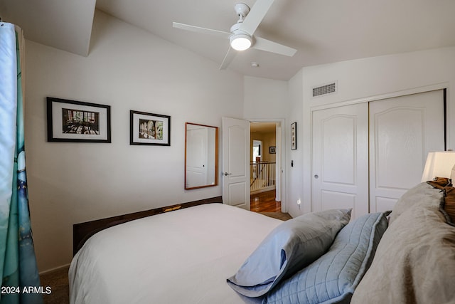 bedroom featuring vaulted ceiling, ceiling fan, a closet, and dark hardwood / wood-style floors