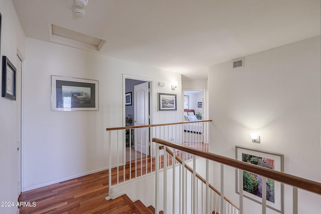 corridor with hardwood / wood-style floors