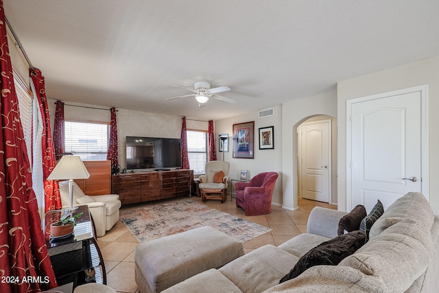 tiled living room with ceiling fan