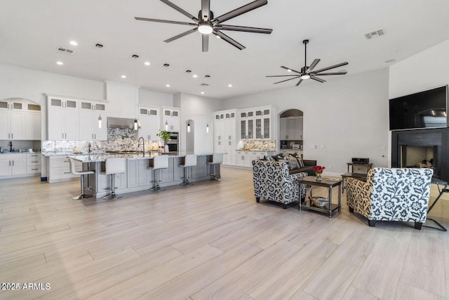 living room featuring ceiling fan and sink