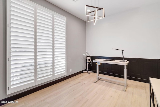 office space featuring light wood-type flooring and a healthy amount of sunlight