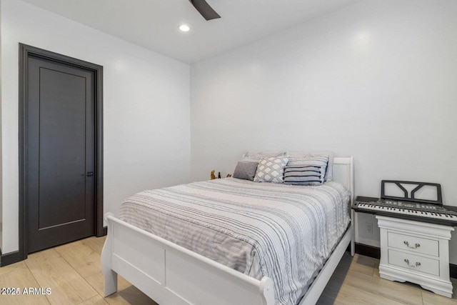 bedroom with ceiling fan and light hardwood / wood-style flooring