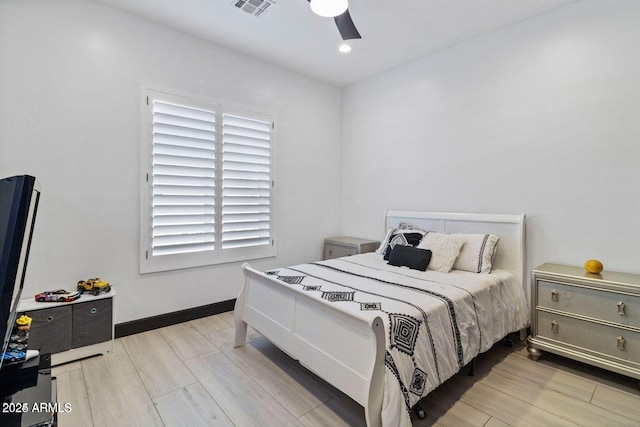 bedroom with ceiling fan and light hardwood / wood-style flooring