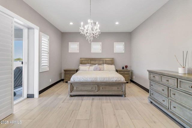 bedroom featuring access to outside, light hardwood / wood-style flooring, and an inviting chandelier