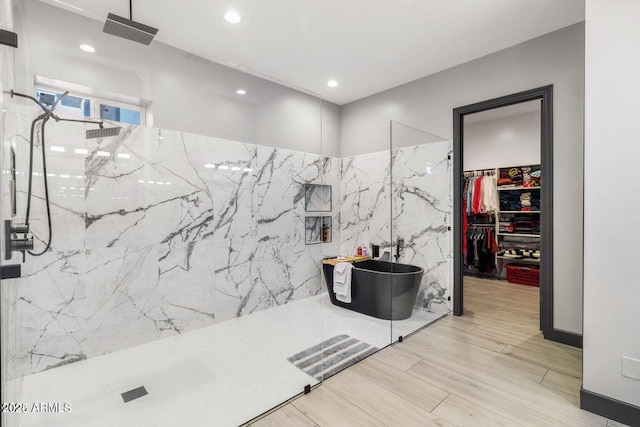 bathroom with tile walls and shower with separate bathtub