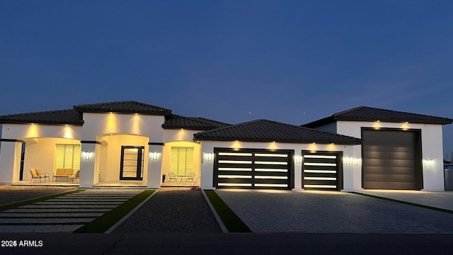 view of front of house with a garage and a patio