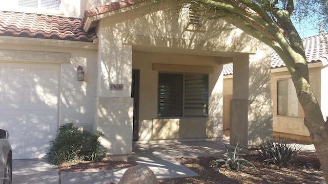 view of exterior entry featuring a garage