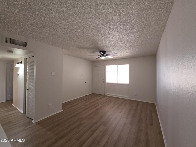 720 S Dobson Rd Unit 24, Mesa, AZ 85202 - unfurnished room featuring a textured ceiling, a ceiling fan, visible vents, wood finished floors, and baseboards