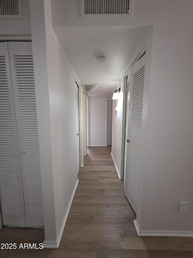 720 S Dobson Rd Unit 24, Mesa, AZ 85202 - hall featuring wood finished floors, baseboards, and visible vents