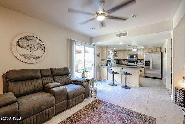 living room with ceiling fan and light tile patterned flooring