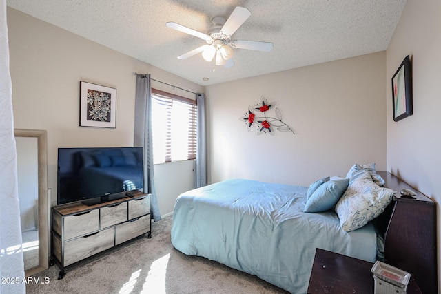 carpeted bedroom featuring ceiling fan and a textured ceiling